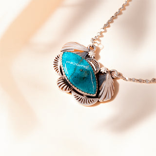Necklace with a turquoise pendant on a light background