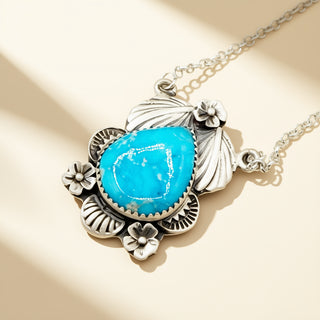 Necklace with a turquoise pendant on a beige background