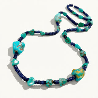Necklace with blue and green beads on a white background