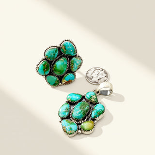 Turquoise jewelry set with ring and pendant on a light background