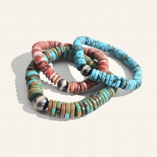 Set of colorful beaded bracelets on a light background