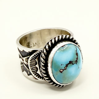 Silver ring with blue stone on a beige background