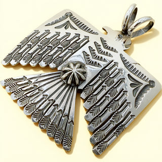 Silver thunderbird pendant on a beige background