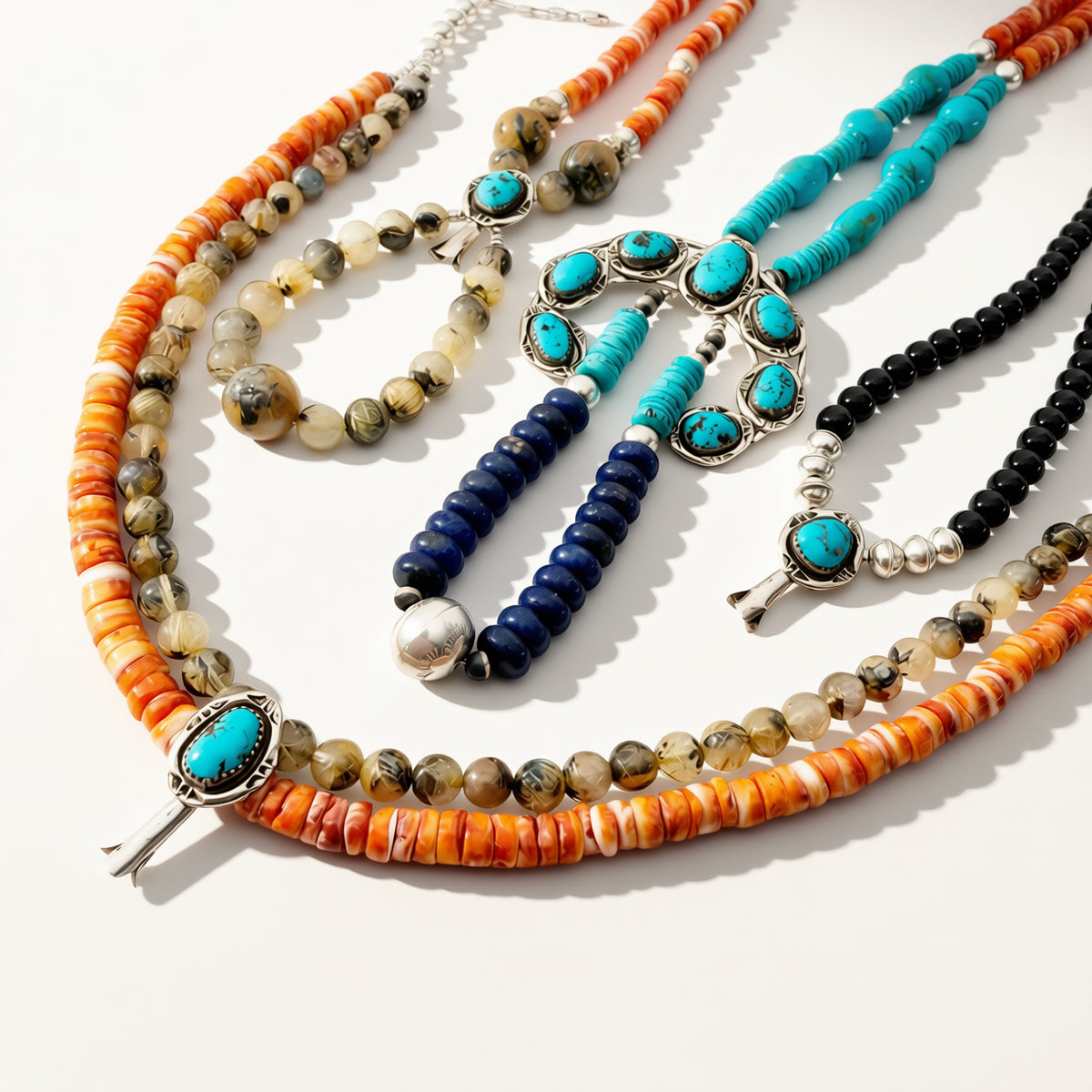Set of colorful beaded necklaces on a white background
