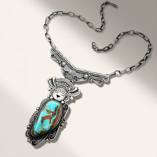 Silver necklace with a turquoise pendant on a light gray background