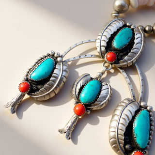 Silver earrings with turquoise and red stones on a light background