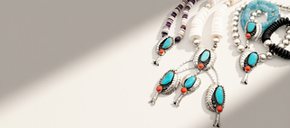 Jewelry set with turquoise and coral accents on a neutral background