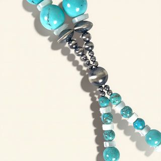 Necklace with turquoise and silver beads on a white background