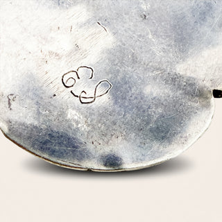 Close-up of a metal surface with an engraved design on a white background