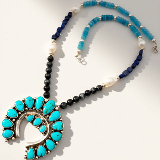Necklace with turquoise stones and black beads on a white background