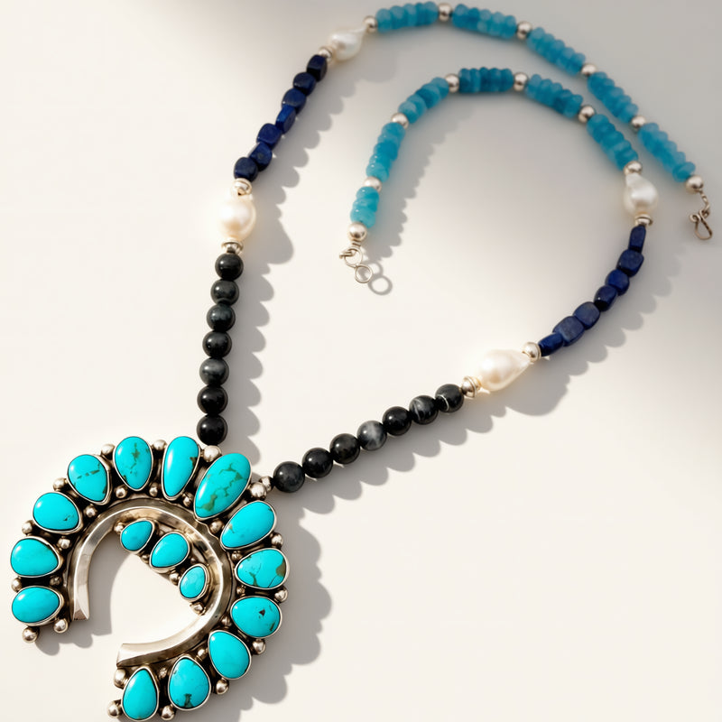 Necklace with turquoise stones and black beads on a white background