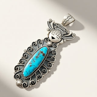 silver maiden pendant with oval turquoise stone on a beige background