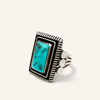 Silver ring with turquoise stone on a white background