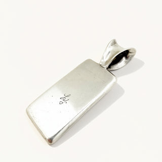 Silver pendant on a white background