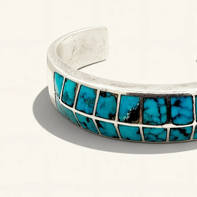 silver jewelry with turquoise stones on a beige background