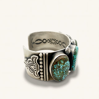 Silver ring with turquoise stones on a white background