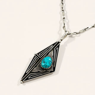 Necklace with a geometric pendant featuring a turquoise stone on a white background