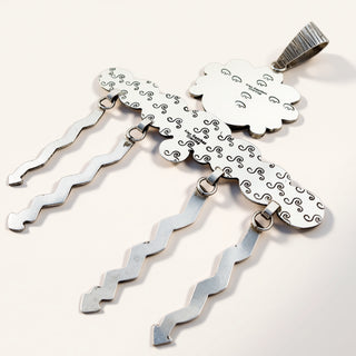 silver jewelry with cloud silhouette on a beige background