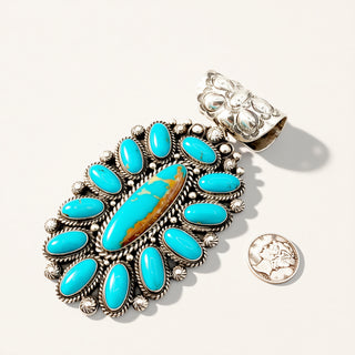 Turquoise stone pendant with silver setting on a white background