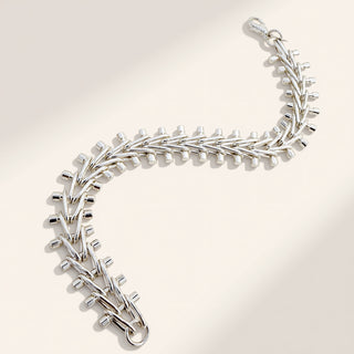 Silver bracelet on a light gray background