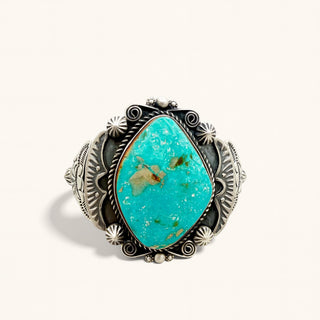Turquoise cuff on a beige background