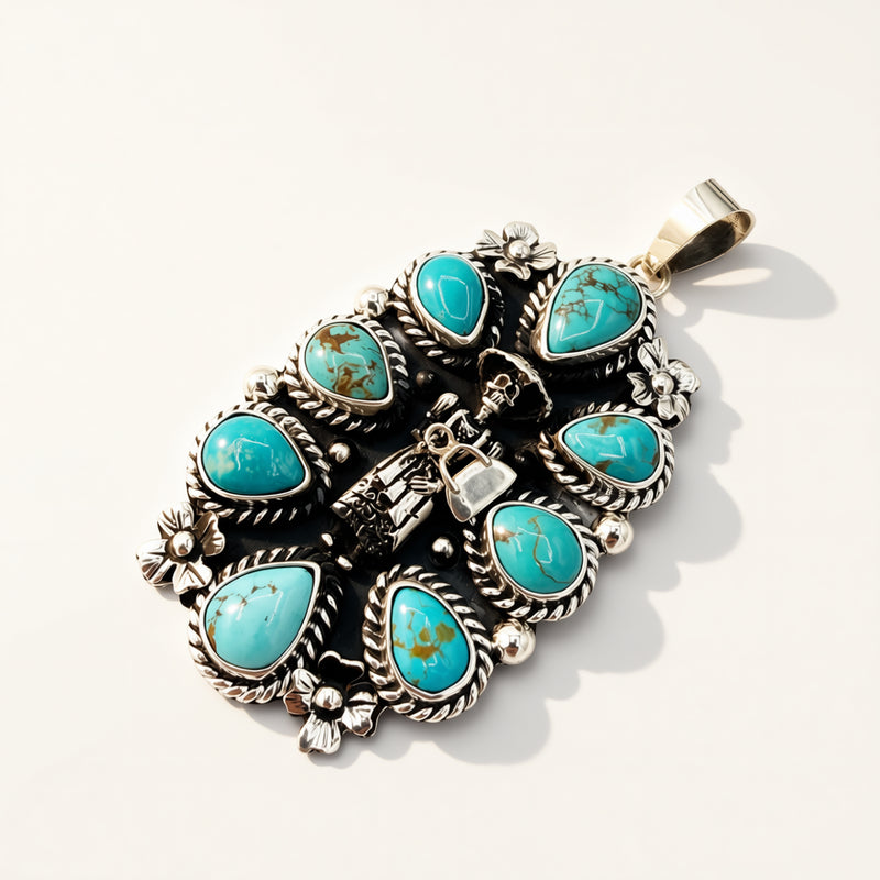 A sterling silver pendant featuring multiple turquoise stones in a Southwestern-style floral arrangement, photographed on a clean white background with soft shadows.