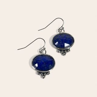 Pair of blue stone earrings on a white background