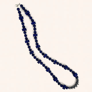 Blue beaded necklace on a white background