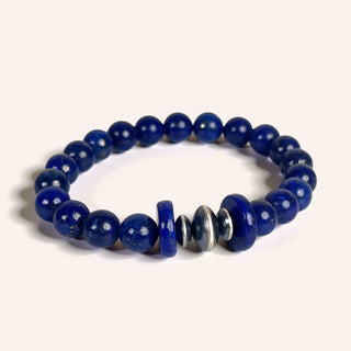 Blue beaded bracelet with a silver accent on a white background