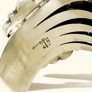 Cuff with a textured band and 'Sterling' marking on a white background