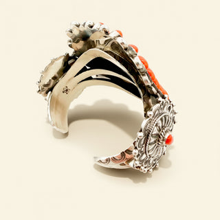 Silver and orange cuff on a beige background