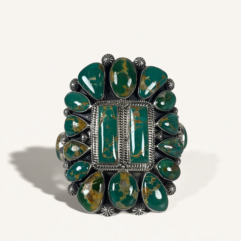 Green stone ring with silver band on a white background