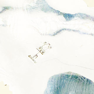 Close-up of a  silver pendant on a white background