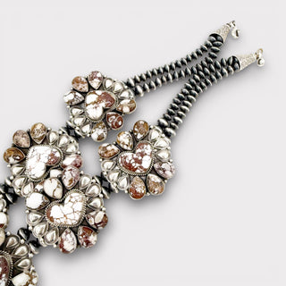 Decorative hairpin with gemstone details on a light gray background