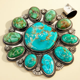 Turquoise stone pendant with silver accents on a beige background