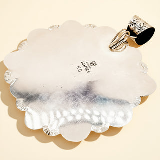 Decorative shell pendant on a beige background