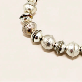 Sterling silver bracelet on a beige background