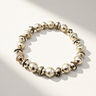 Silver beaded bracelet on a light background