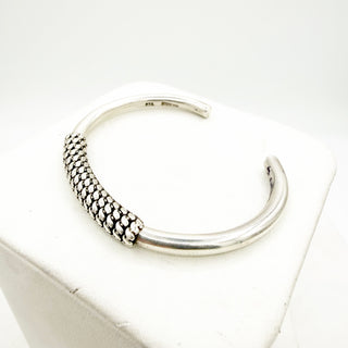 Silver hoop earring on a white background