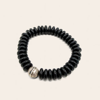 black beaded bracelet on beige background