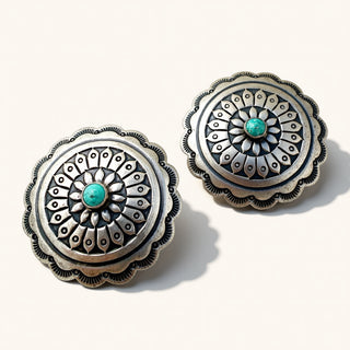 Silver earrings with turquoise stone on beige background