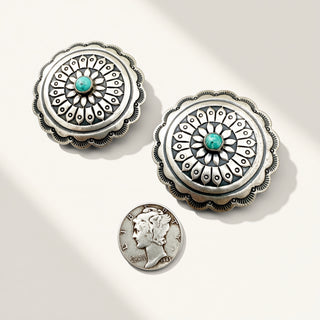 silver earrings with turquoise stone and coin on a beige background