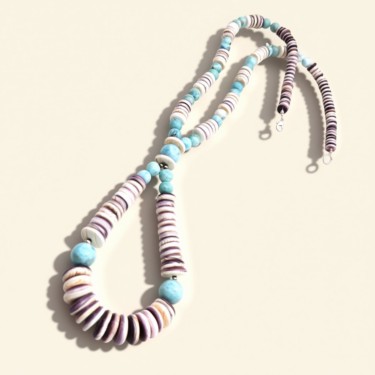 Necklace with striped beads on a beige background
