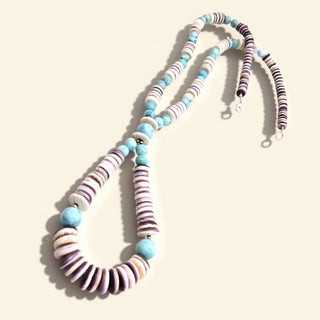 Necklace with striped beads on a beige background