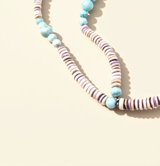 Necklace with multicolored beads on a light beige background