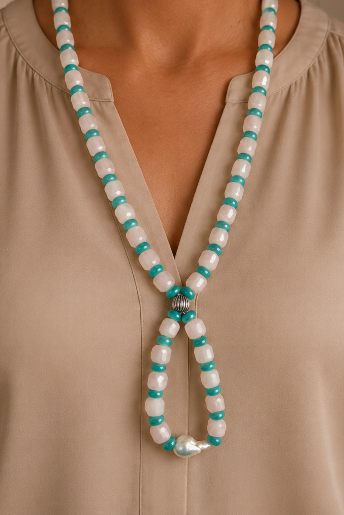 Neck showing pink and turquoise beaded necklace 