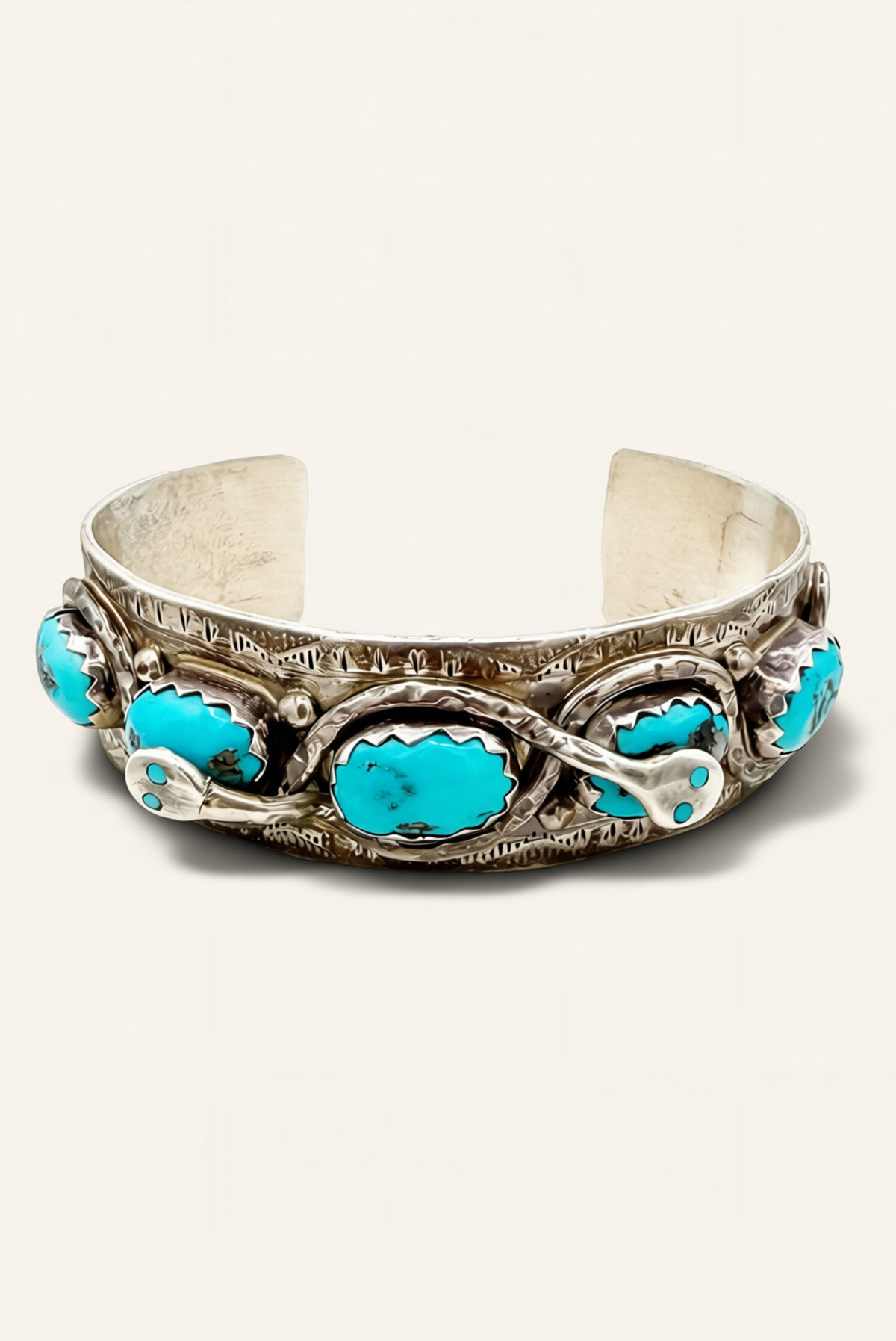 Silver cuff with turquoise stones on a white background