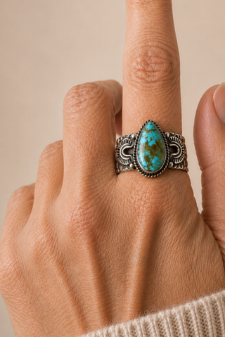 Teardrop turquoise on a finger 