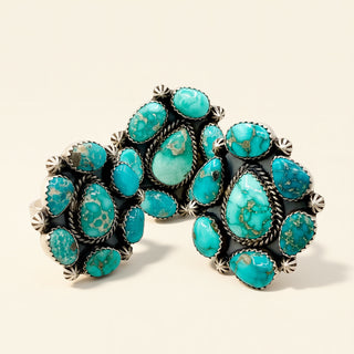 Turquoise stone rings on a beige background
