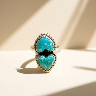 Ring with turquoise stones on a beige background